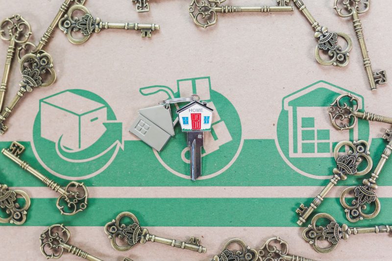 Vintage keys alongside a modern house key, representing real estate investment.