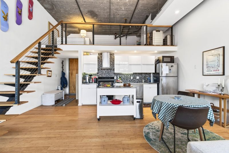 Spacious Boston loft apartment with a modern kitchen, featuring industrial design elements and open living space.